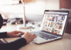 Image of a person's hands on a laptop computer browsing the web