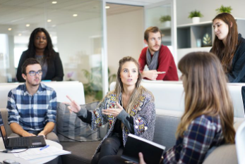 Office workers standing and sitting