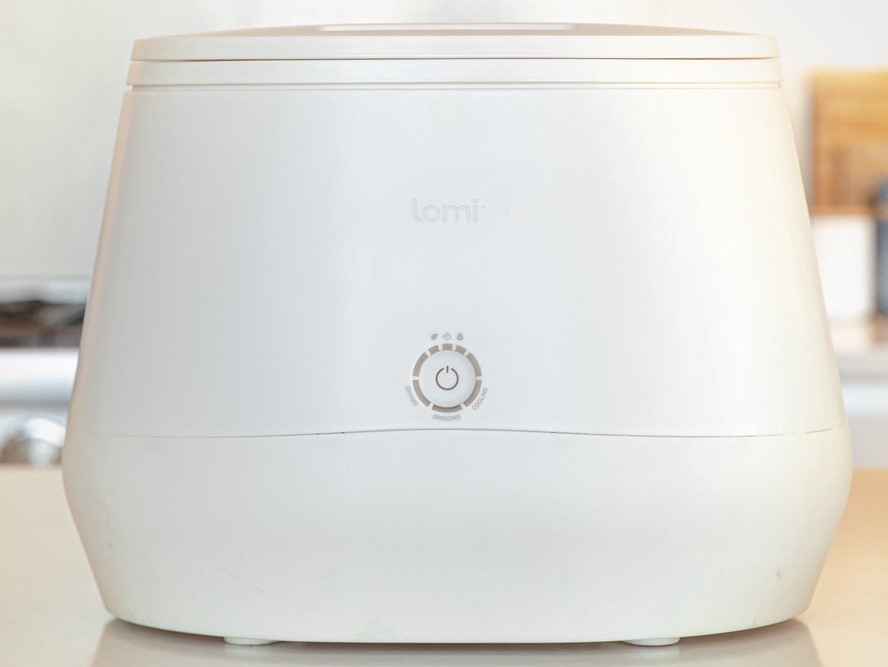 Front view of Lomi Composter sitting on a kitchen counter.