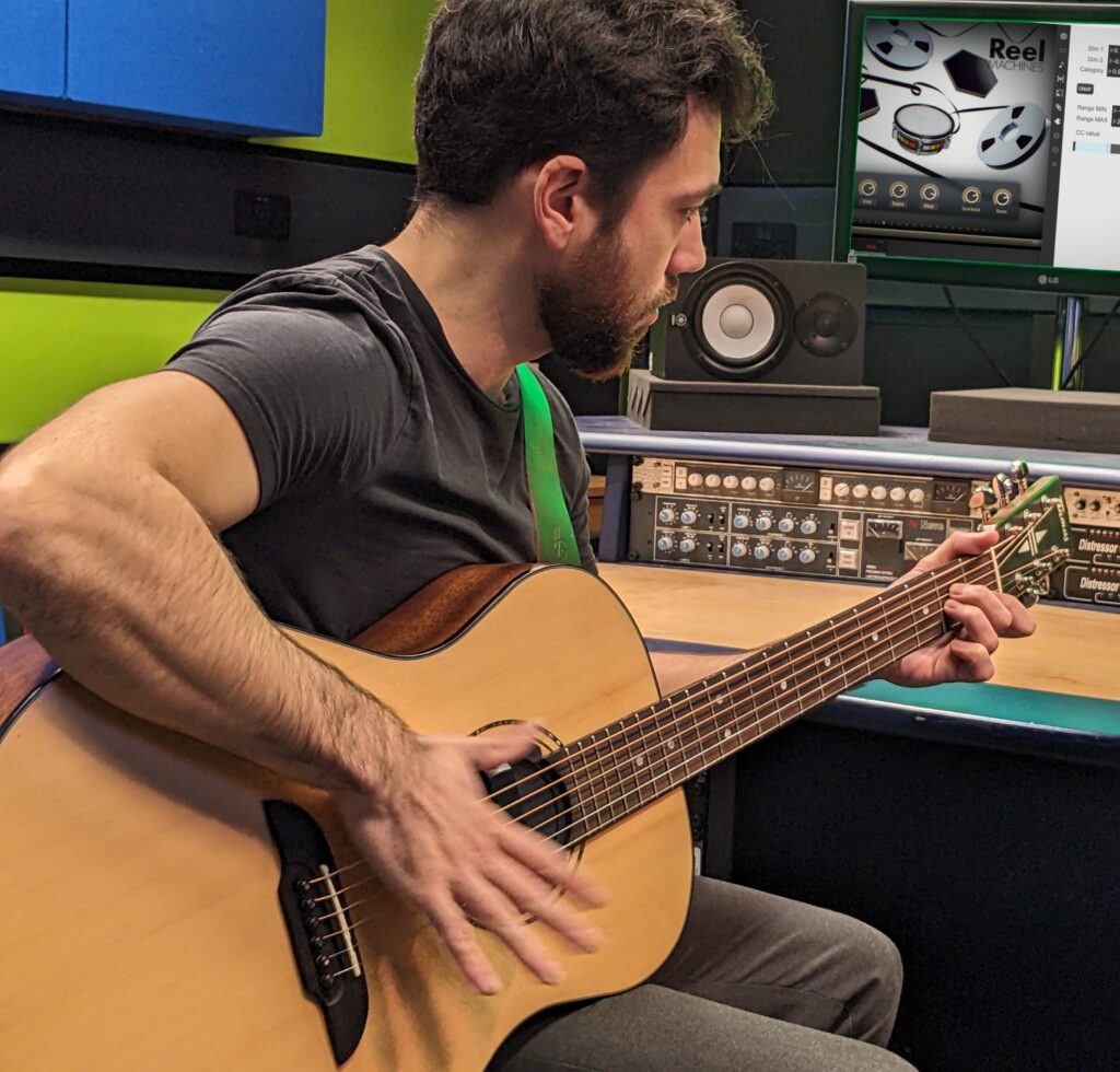HITar prototype smart guitar being played by one of its designers inside his recording studio.