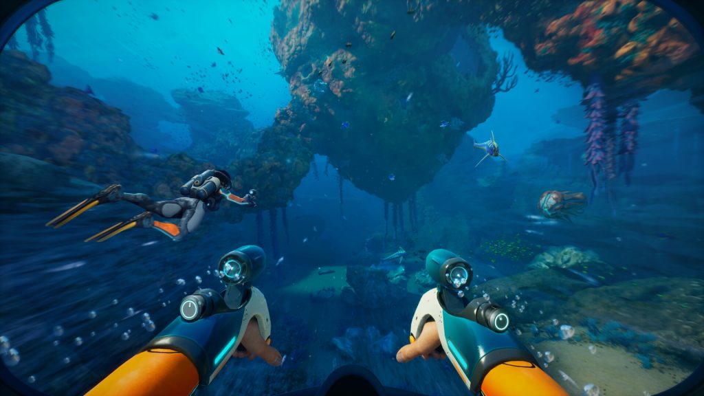 Subnautica 2 screenshot with first-person view of deep water rock structures and a multiplayer diving companion.