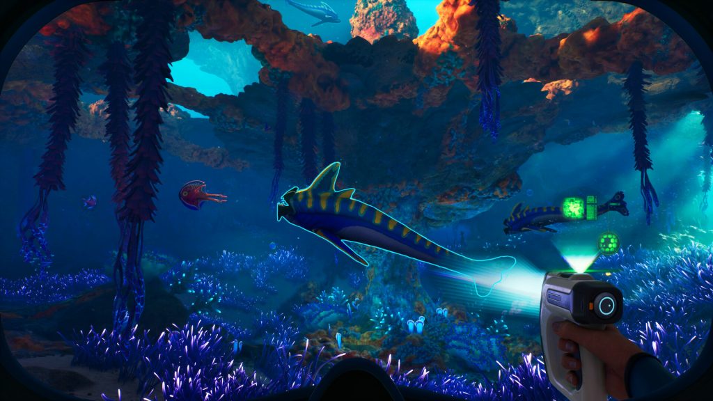 Subnautica 2 screenshot with first-person view of a handheld scanner gathering information from an alien fish.