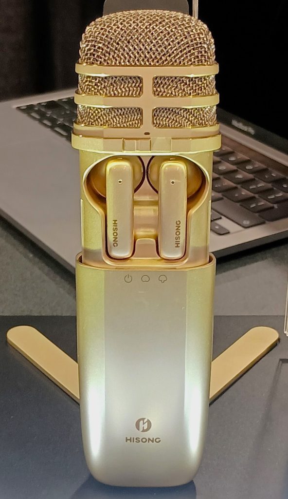 Hisong AirStudio One microphone in gold, with earbuds shown inside case.