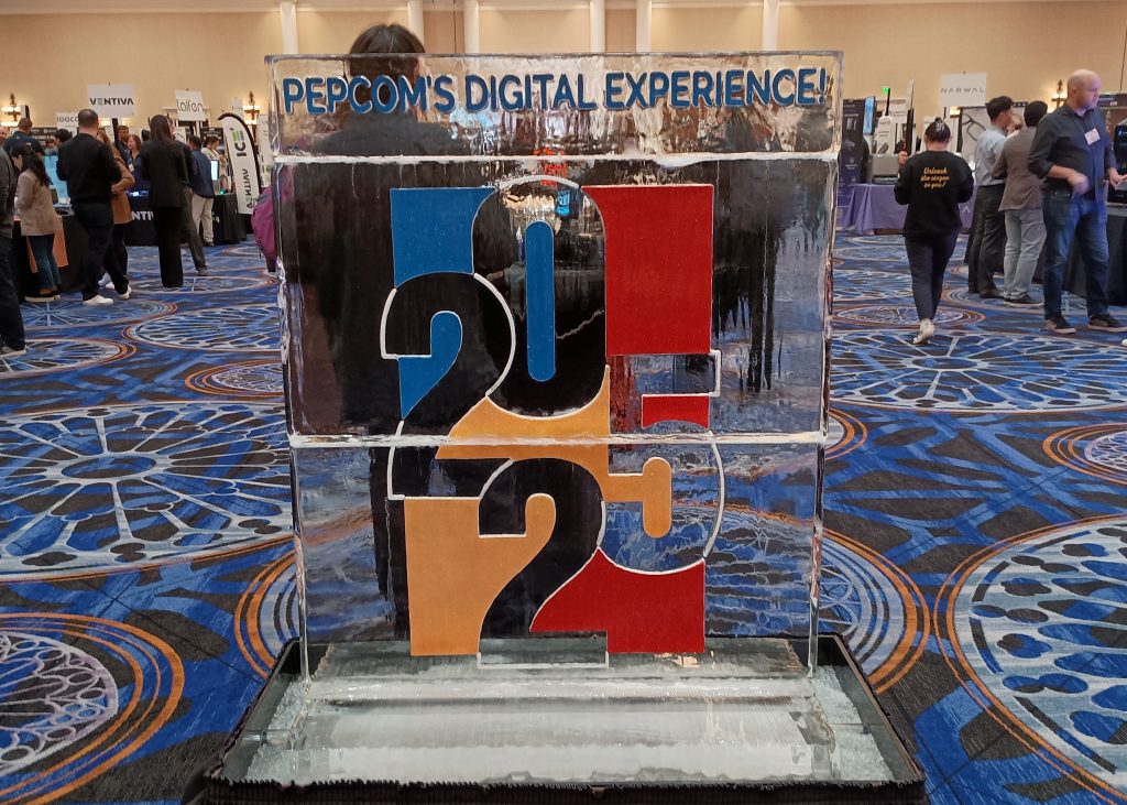 Ice sculpture with the logo for Pepcom's Digital Experience 2025 at the entrance to the ballroom.