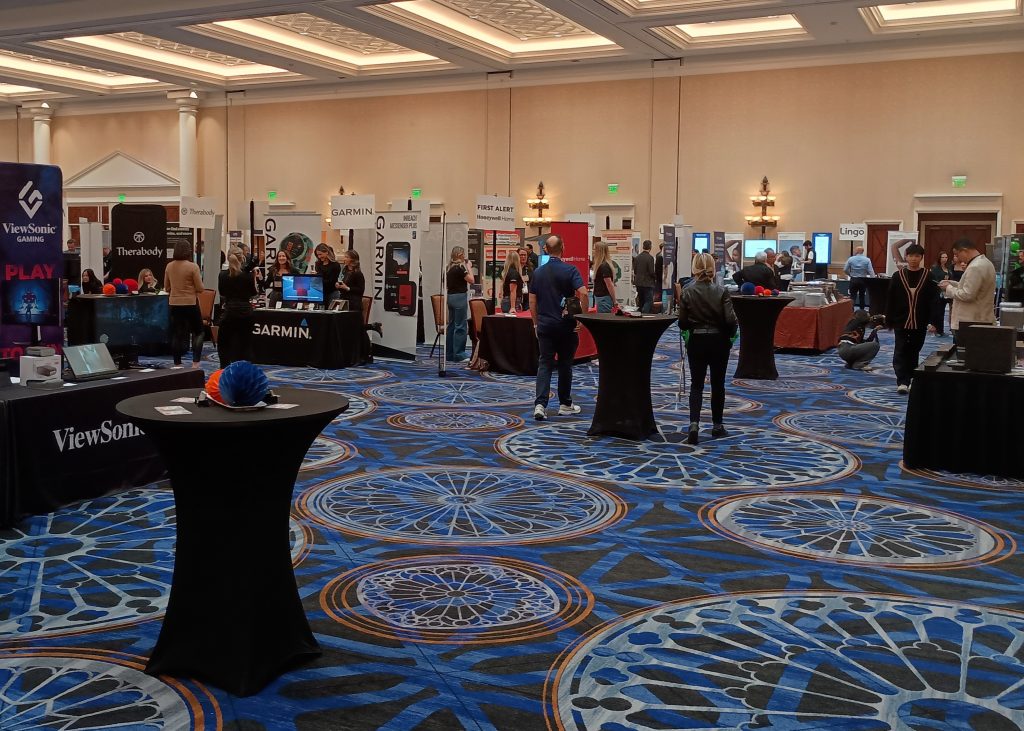 Rows of booths and tables featuring multiple companies and products inside the ballroom for Pepcom's Digital Experience event.