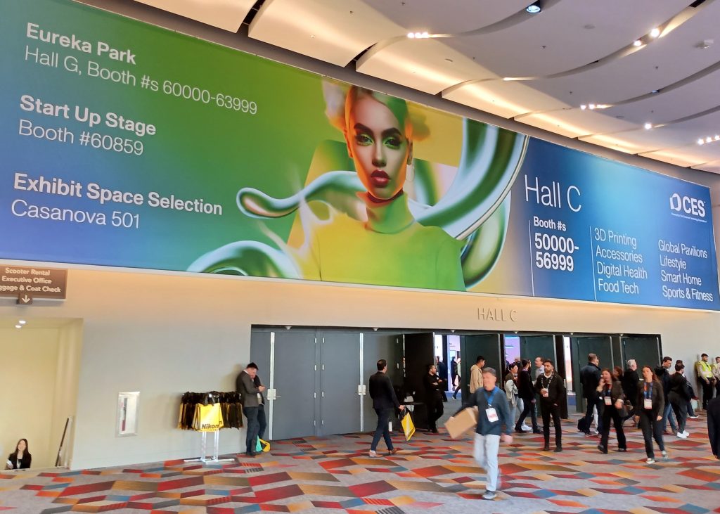 Entrance to Venetian Expo Hall C with large CES 2025 banner above the doors and attendees walking by.