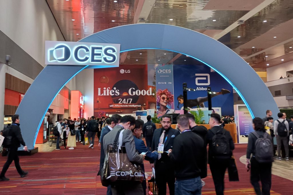 CES logo arch inside the Central Hall Concourse at the Las Vegas Convention Center, with attendees gathered around.