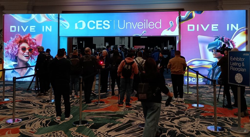 Entryway arch with attendees walking into CES Unveiled.