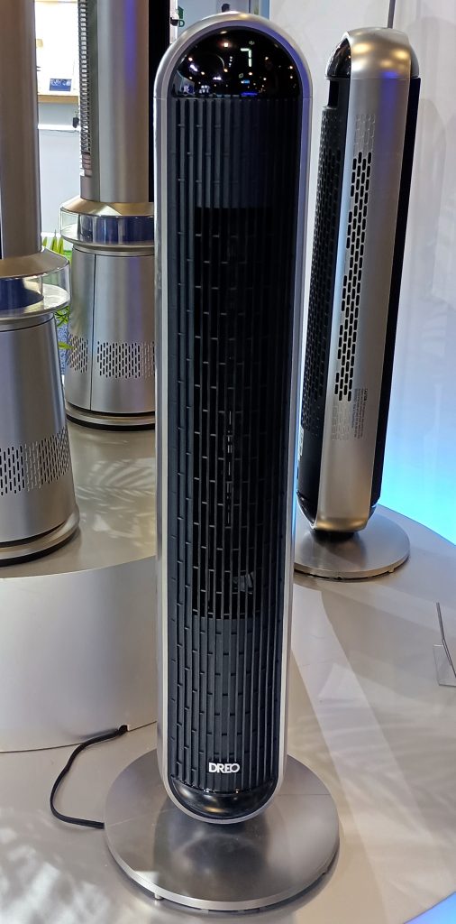 The DREO MC706 2-in-1 Tower Heater & Fan facing front, with other tower fan models behind.