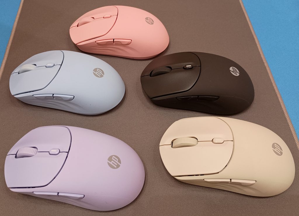 Set of 5 HP 400 Quiet Mice in purple, tan, blue, black, and pink arrayed on a mousepad.