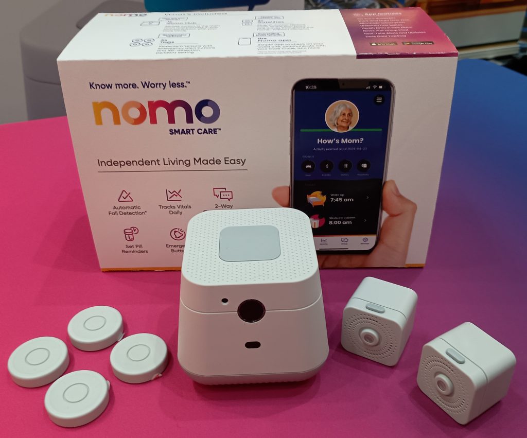 Nomo Smart Care box with wireless hub and sensors on the tabletop.