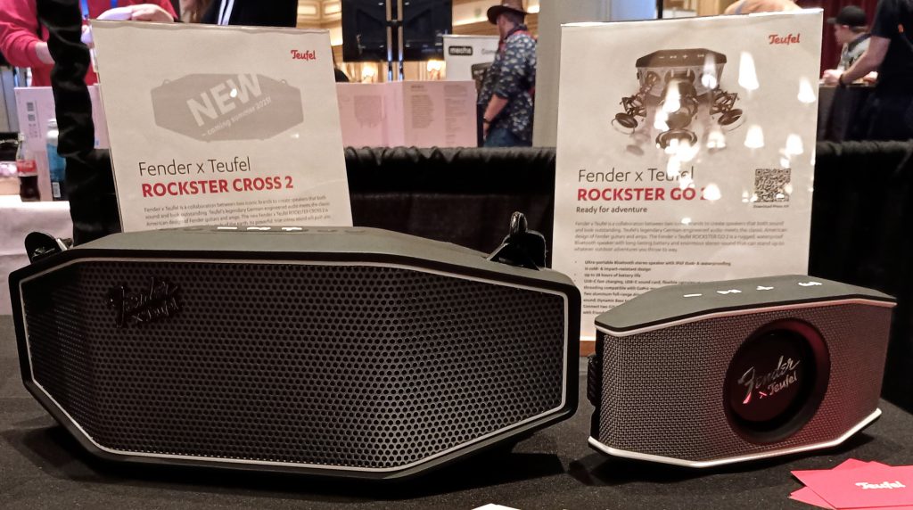 Teufel and Fender branded Bluetooth speakers on a tabletop, the Rockster Cross on the left, the Rockster Go 2 on the right.