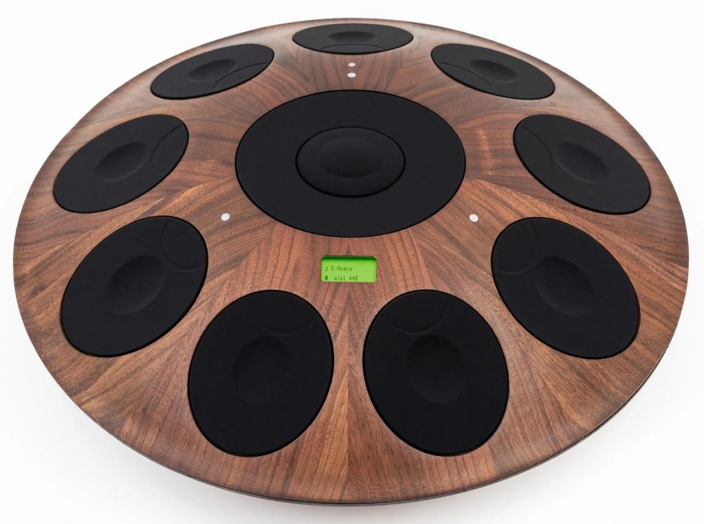 Wooden NEOTONE Digital Handpan instrument in dark brown wood, with black digital touch pads around the edges.