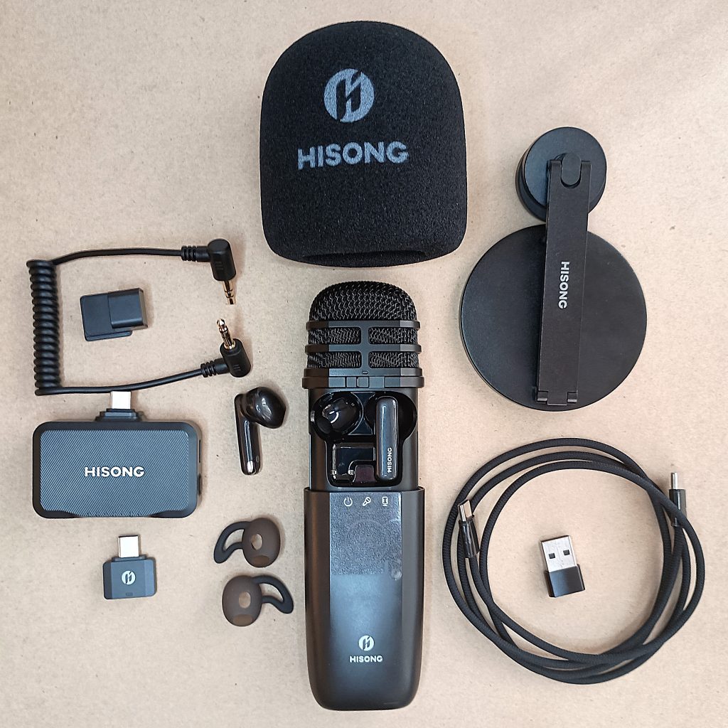 Hisong AirStudio S1 full kit, with mic, earbuds, foam windscreen, stand, USB connection devices, silicone earbud tips, and power cable.