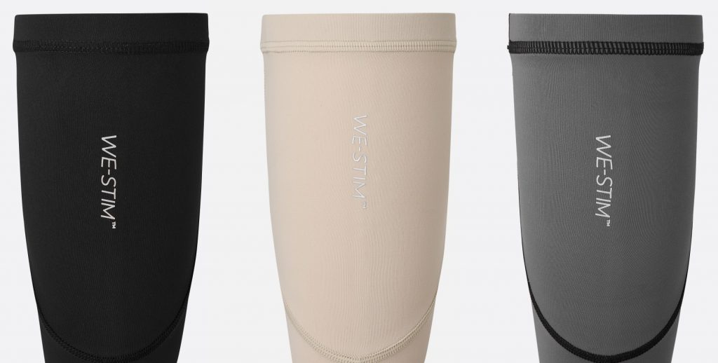 Black, cream, and grey WE-STIM Calf Sleeves with structural seams and brand logos on a white background.
